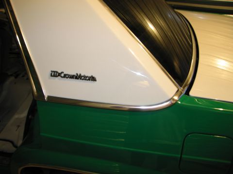 1991 Ford LTD Crown Victoria - Close-up of a two-tone green and white car's rear pillar, showing the "LTD Crown Victoria" emblem.