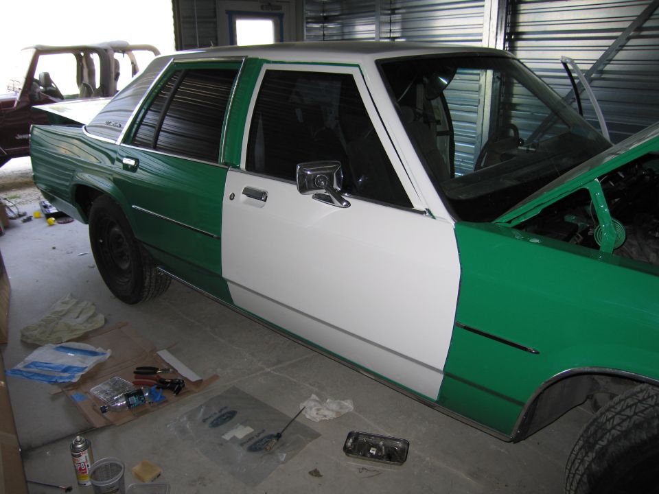 Green and white 1991 Ford Crown Victoria LTD side view, undergoing paintwork