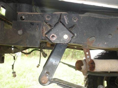 1996 Ford F-150 - Close-up view of a rear suspension component and exhaust pipe on a truck.