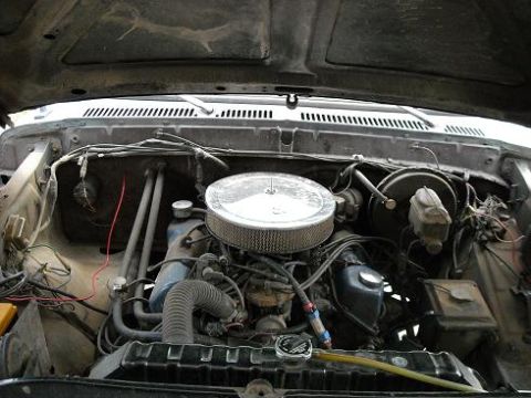 1978 Ford Bronco - The engine bay of a vehicle, showing various components and wiring.