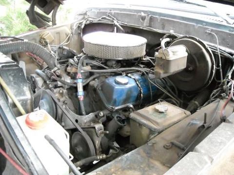 1978 Ford Bronco - The engine compartment of a vehicle, showing the V8 engine and various components.