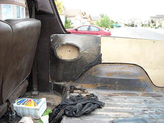 1978 Ford Bronco - View of the cargo area interior, showing unfinished wood paneling and brown upholstery. A SuperMotors logo is present in the lower right.
