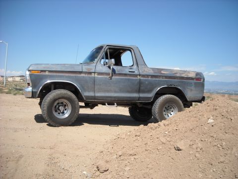 1978 Ford Bronco - This 1978 Ford Bronco is navigating a challenging dirt terrain with its lifted suspension.