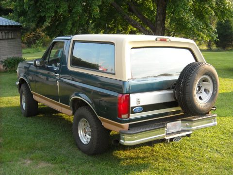 1994 Ford Bronco - This 1994 Ford Bronco is shown in a rear quarter view, its distinctive two-tone paint scheme and external spare tire.