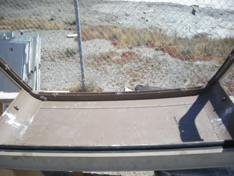 1991 Ford Bronco - The interior of a brown vehicle is visible, including the cargo area and door frame. The registry claims it is a 1991 Ford Bronco, but this…