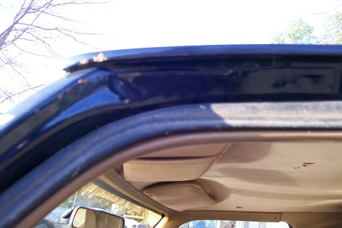 1988 Ford Bronco - The interior roofline of the vehicle shows signs of wear and rust along the edges.