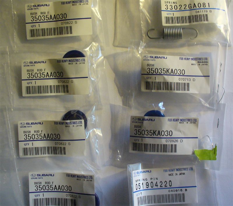 Sealed Subaru genuine shifter bushings, spring and spring pin in labeled parts bags