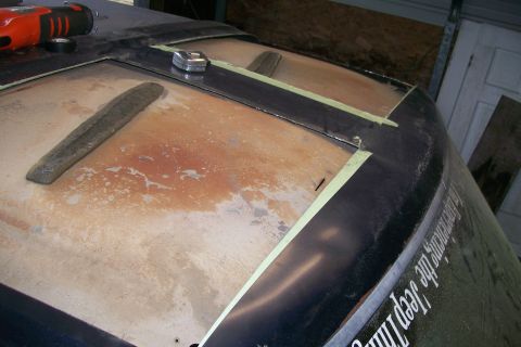 1988 Ford Bronco - A vehicle's roof is being worked on, with visible rust and tools present.