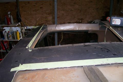 1988 Ford Bronco - The roof of a vehicle is being cut and prepped for a t-top conversion, with tape applied to the edges.