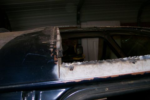 1988 Ford Bronco - The roof of a vehicle is being cut open, likely for a custom modification.