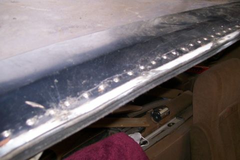 1988 Ford Bronco - Close-up of chrome trim with rivets, possibly from an interior panel.