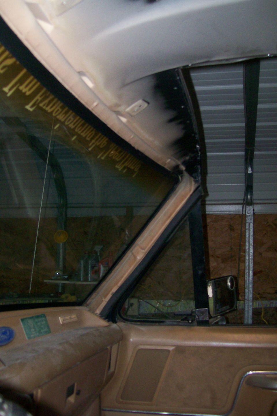 Passenger-side truck interior showing tan A-pillar trim, dash and exposed roof metal