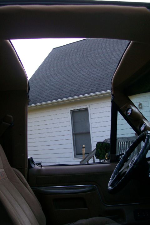 1988 Ford Bronco - The open t-top reveals a view of the surrounding house and yard.