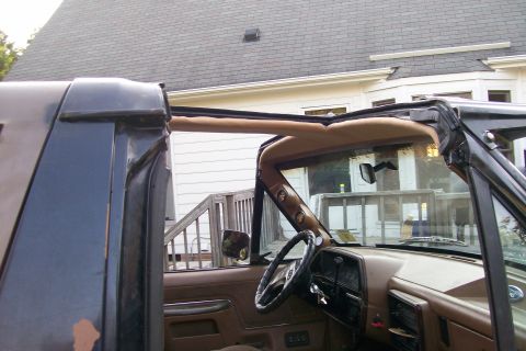 1988 Ford Bronco - Interior view of a 1988 Ford Bronco with its T-top removed, revealing the dashboard and steering wheel.