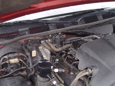 1999 Mercury Grand Marquis - Close-up view of the engine compartment, showing various hoses and electrical connections.