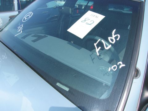 2001 Ford Crown Victoria - Handwritten markings on the windshield obscure the interior details of the car.