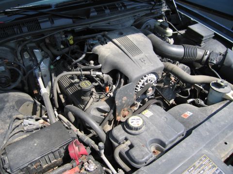 2001 Ford Crown Victoria - Close-up view of the engine bay, showing the V8 engine cover and coolant reservoir.
