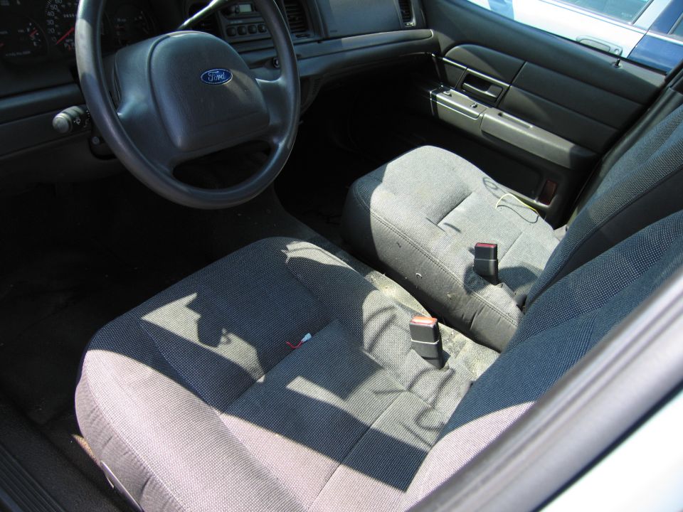 Interior of a 2001 Ford Crown Victoria, showing the steering wheel, dashboard, and front seats