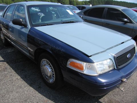 2001 Ford Crown Victoria - The front quarter view of a 2001 Ford Crown Victoria shows a two-tone paint scheme with a light blue hood and dark blue fenders.