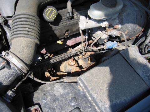 2001 Ford Crown Victoria - Close-up view of an engine bay, showing various components including the air intake hose and brake fluid reservoir.