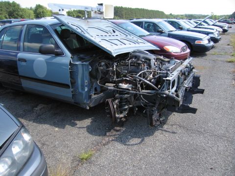 2001 Ford Crown Victoria - This 2001 Ford Crown Victoria is in a junkyard, missing its front bumper and grille.