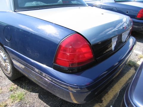 2001 Ford Crown Victoria - Rear view of a blue 2001 Ford Crown Victoria, showing its distinctive taillight and body lines.