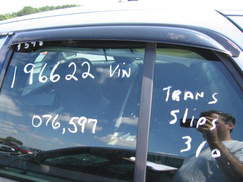 2001 Ford Crown Victoria - Handwritten notes on a car window indicate VIN, mileage, and transmission slip information.