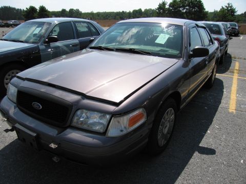 2001 Ford Crown Victoria - This 2001 Ford Crown Victoria is shown from the front-right, with its hood open. Another vehicle is visible to the left.