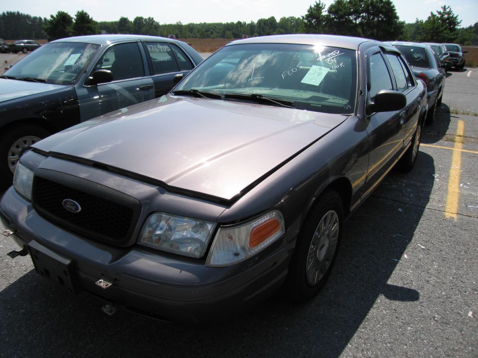 Gray 2001 Ford Crown Victoria, 3/4 front view. Hood is ajar