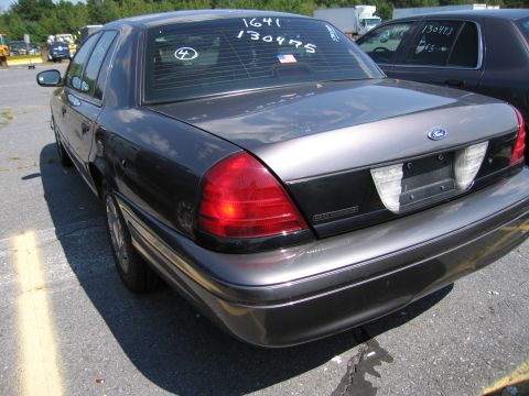 2001 Ford Crown Victoria - The rear of a 2001 Ford Crown Victoria is shown, with handwritten numbers on the rear window.