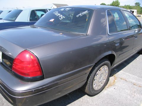 2001 Ford Crown Victoria - Rear view of a 2001 Ford Crown Victoria, showing the taillight and rear window with markings.