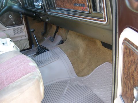 1979 Ford Bronco - The interior of a 1978 Ford Bronco XLT shows woodgrain trim and a manual transmission shifter.