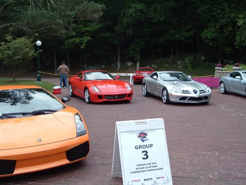 1999 Mercury Grand Marquis - A collection of exotic sports cars are gathered, including a Lamborghini, Ferrari, and Mercedes-Benz SLR McLaren.