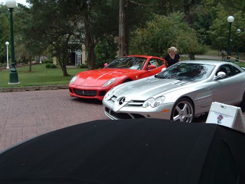 1999 Mercury Grand Marquis - Two exotic sports cars, a silver Mercedes-Benz SLR McLaren and a red Ferrari 599 GTB Fiorano, are displayed outdoors.