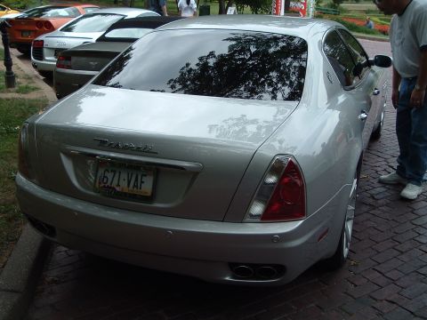 1999 Mercury Grand Marquis - Silver Maserati Quattroporte with a license plate reading 671-VAF is parked on a brick road.