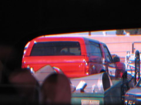 1986 Ford Bronco - Rear view of a red SUV with a cap, possibly from the 1980s.