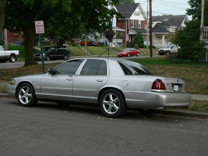 Rear three-quarter view of a silver Mercury Marauder sedan parked on a residential street