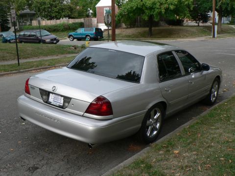 2004 Mercury Marauder - A silver 2004 Mercury Marauder is parked curbside on a street with houses and trees in the background.
