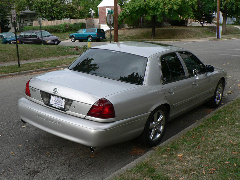 Silver 2004 Mercury Marauder parked on the side of a residential street, rear view