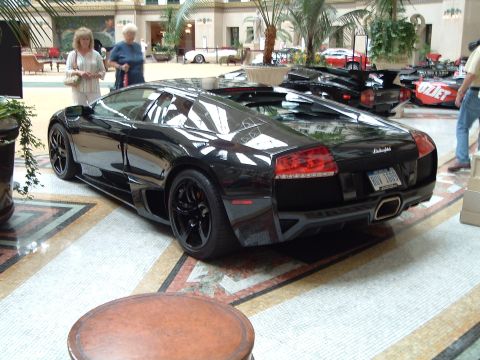 1999 Mercury Grand Marquis - Black Lamborghini with a license plate that reads 'DUV 1606' is displayed indoors.