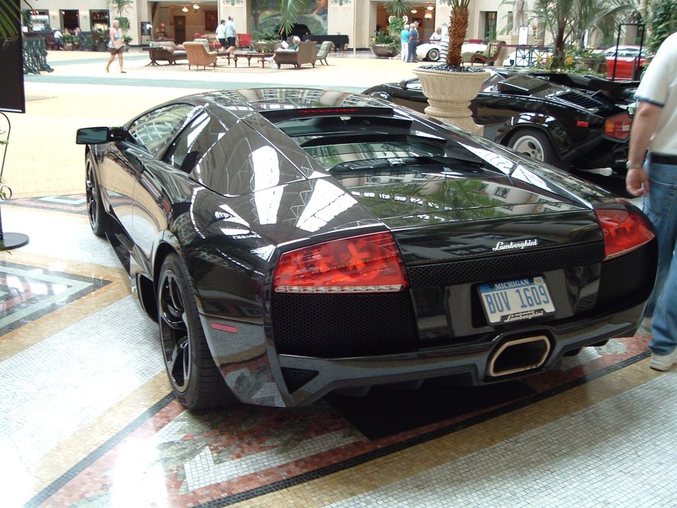 Black Lamborghini Murcielago LP640 rear view on mosaic floor at an indoor car display