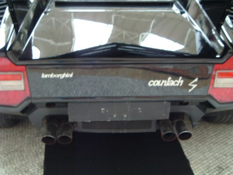 1999 Mercury Grand Marquis - Rear view of a Lamborghini Countach S, showing its distinctive quad exhaust pipes and badging.