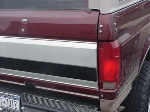 1996 Ford Bronco - The rear of a maroon Ford Bronco shows its distinctive body style and chrome accents.
