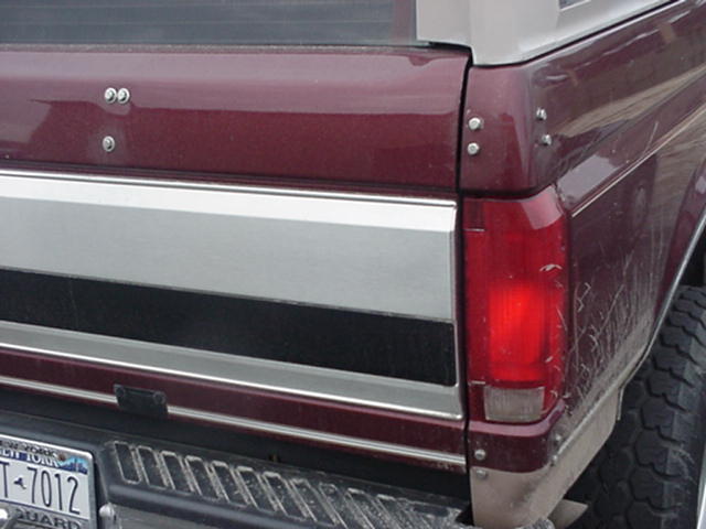 Maroon Ford Bronco rear quarter panel with chrome trim and a visible taillight