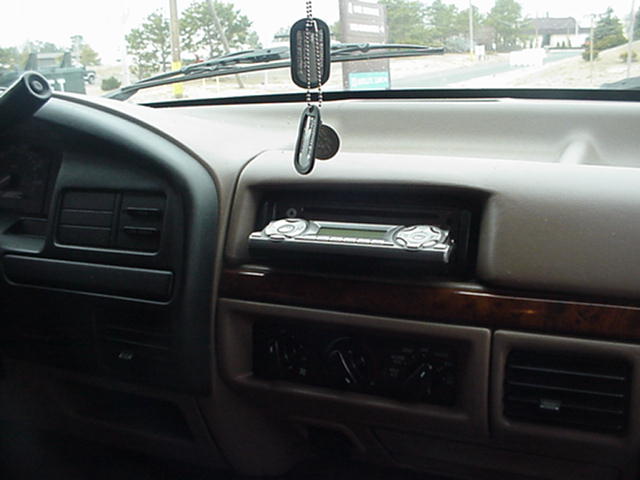 Interior dashboard with aftermarket stereo and dog tags
