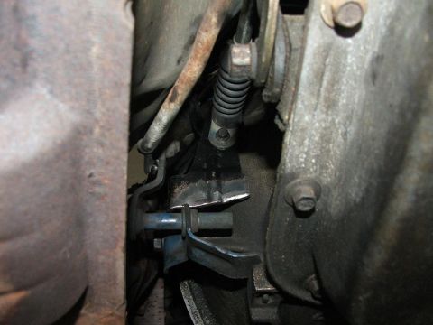 1985 Ford LTD Crown Victoria - Underside view of a vehicle's transmission linkage mechanism.