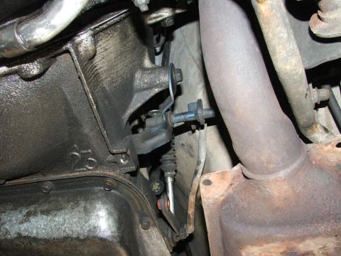 1985 Ford LTD Crown Victoria - Close-up view of a vehicle's undercarriage, focusing on the transmission and exhaust components.