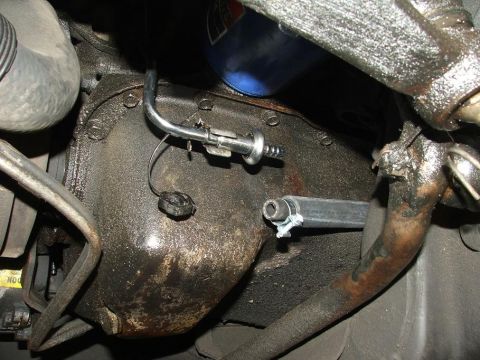 1985 Ford LTD Crown Victoria - Close-up view of engine oil filter and transmission lines.