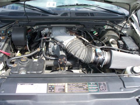 2007 Ford Mustang - The engine bay of a vehicle is shown, various components and hoses.