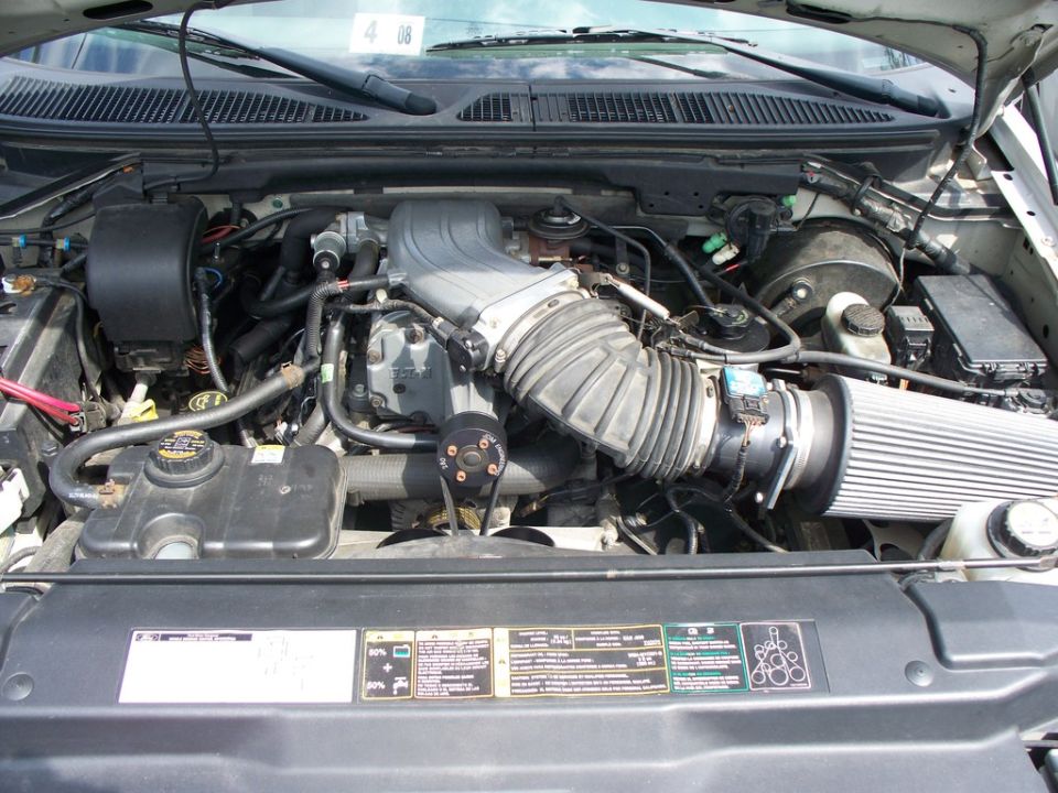 engine bay with air intake and hoses visible